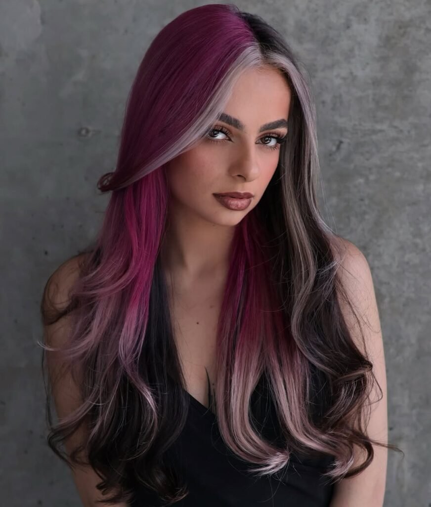  Woman with sleek, split-dye hair in magenta and ash blonde tones — a playful and modern choice for Fall Hair Colors.