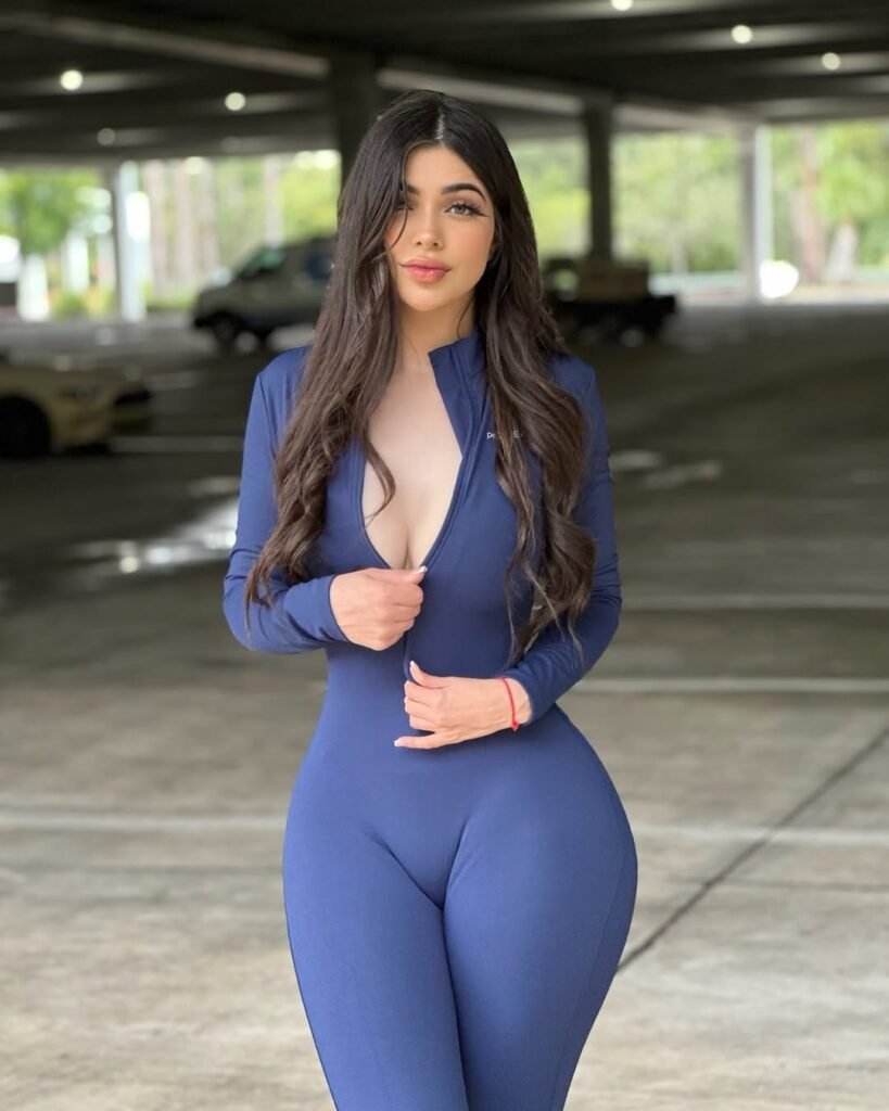 Gym outfit inspo in a bold navy blue zip-up bodysuit with a deep neckline, styled for a confident gym aesthetic.