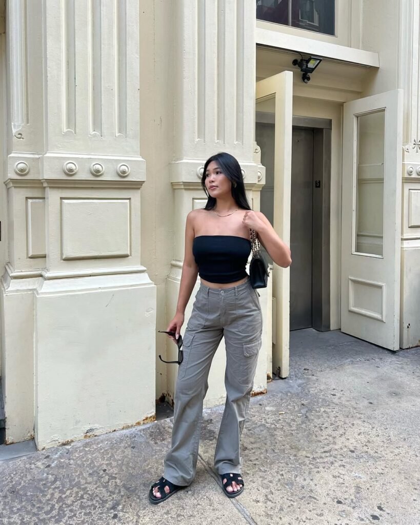 Street style outfit inspo with a black bandeau top and utility pants.