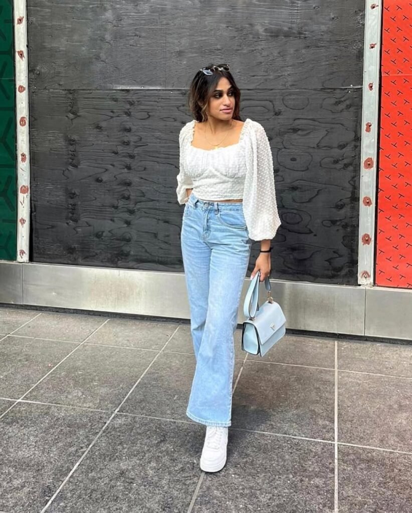 Feminine outfit inspo featuring a white puff-sleeve blouse and light wash jeans.