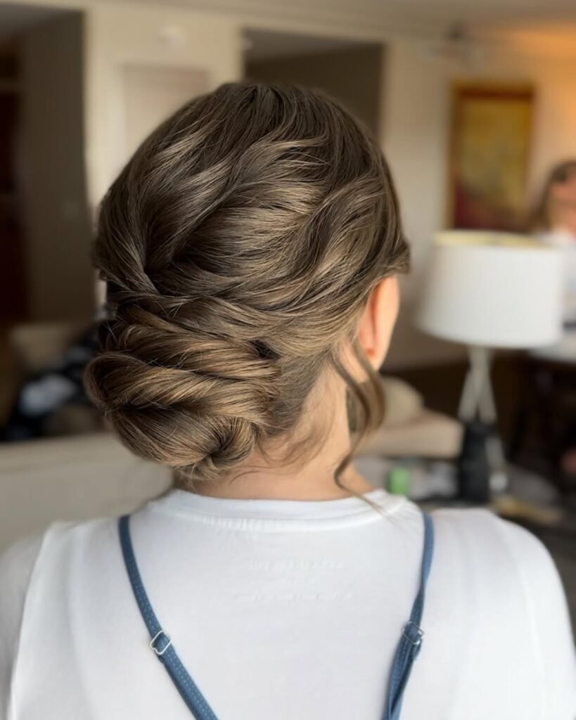 Twisted low bun with a smooth finish – elegant hairstyle idea.