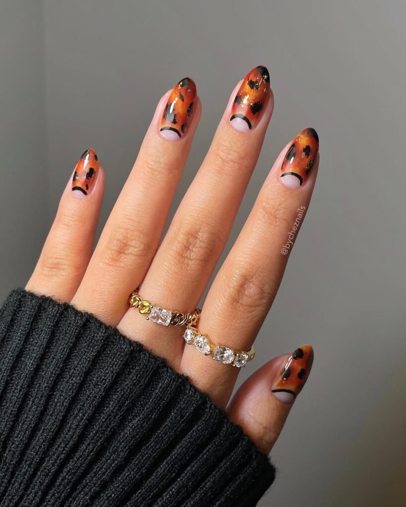 Glossy tortoiseshell nails with crescent cutouts — an edgy statement for your Night Out Outfit.