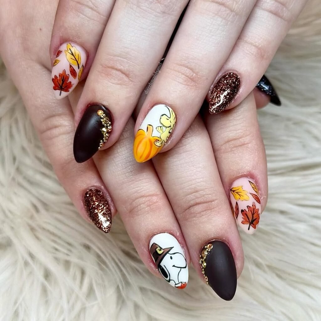 Cute Thanksgiving-inspired Fall Nail Colors with pumpkins, Snoopy, and autumn leaves.