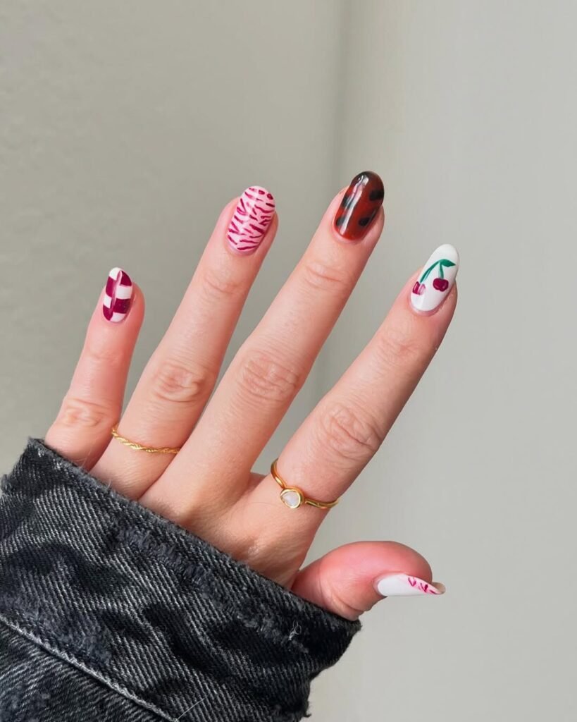 Fun mix-and-match Fall Nail Colors with cherries, animal prints, and abstract designs.
