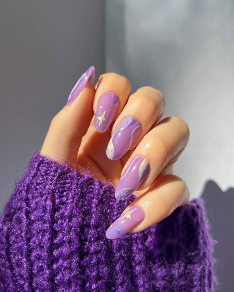 Light purple Fall Nail Colors with star accents and glitter waves on glossy nails.