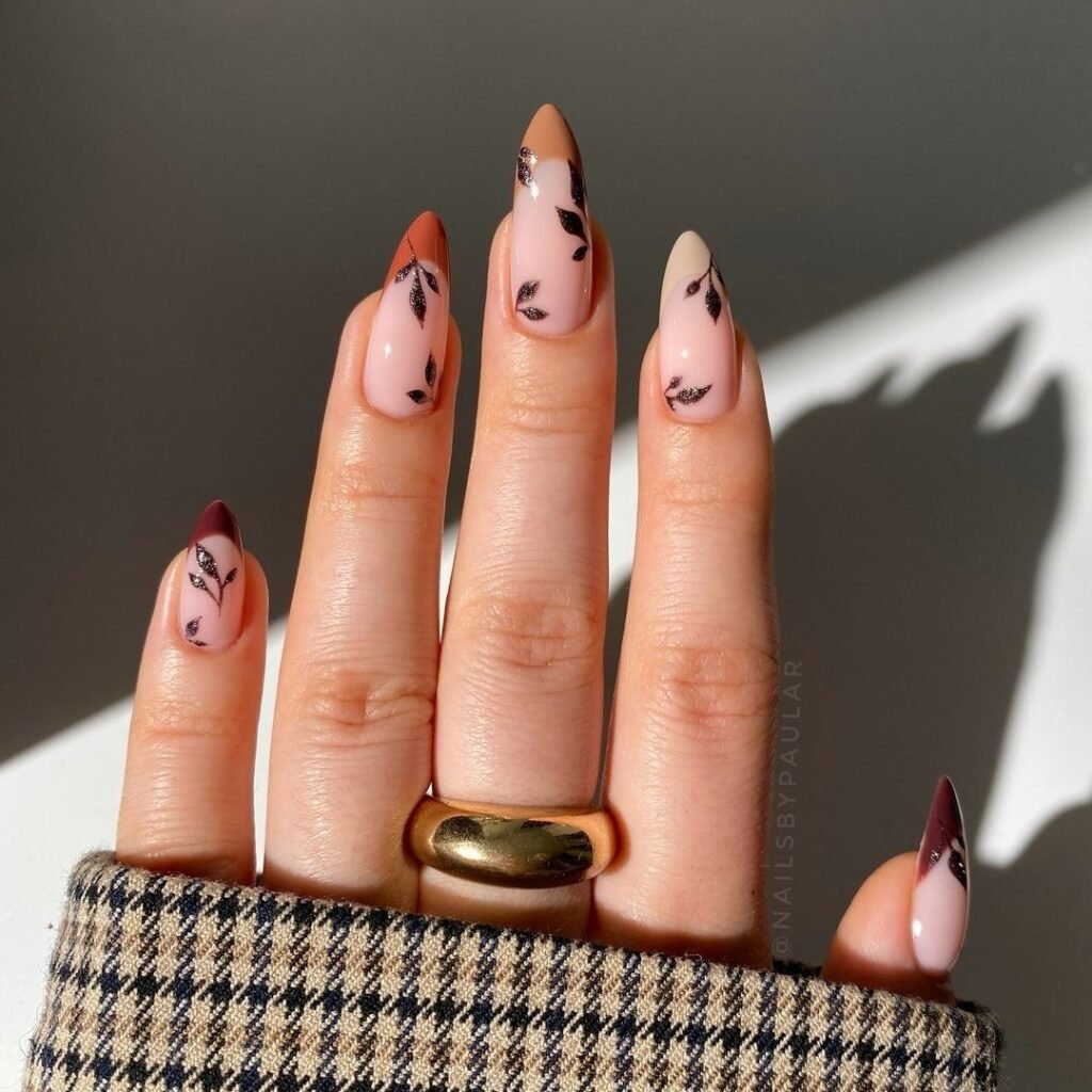 Chic minimalist Fall Nail Colors with leaf accents and gradient French tips in neutral tones.