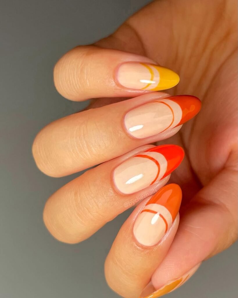 Fun orange and yellow abstract French tip nails — a playful accent to your vibrant Night Out Outfit.
