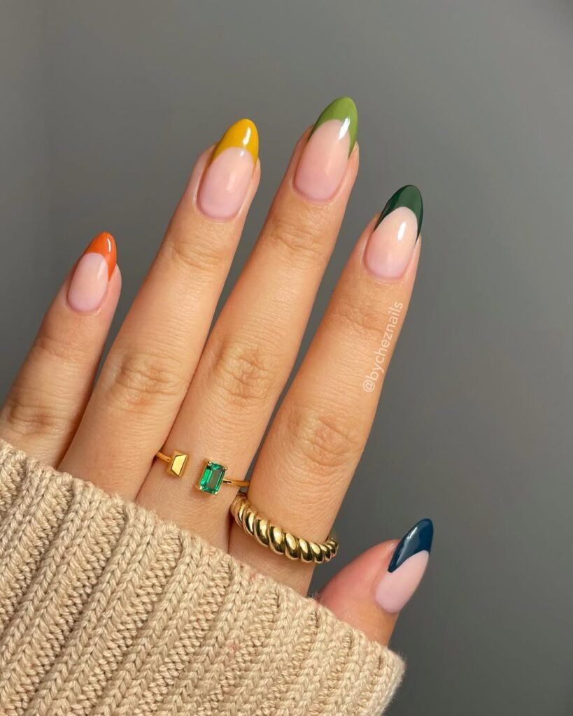 Colorful fall-themed French tip nails in warm tones — the perfect accessory for your bold Night Out Outfit.