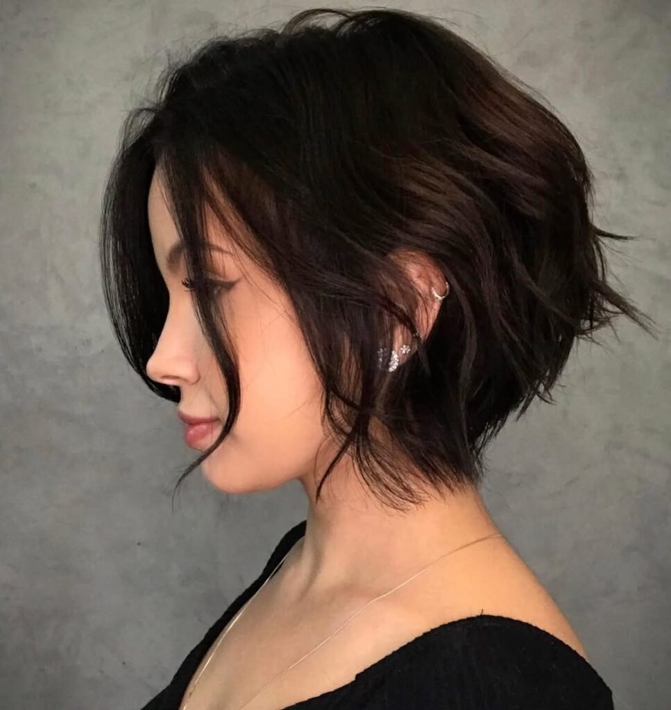 Side profile of a textured short bob with soft waves, perfect example of cute hairstyles for short hair.
