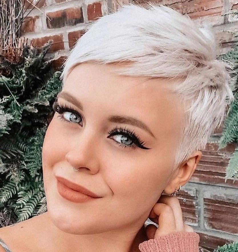 Woman with icy blonde pixie cut, highlighting bold and cute hairstyles for short hair.