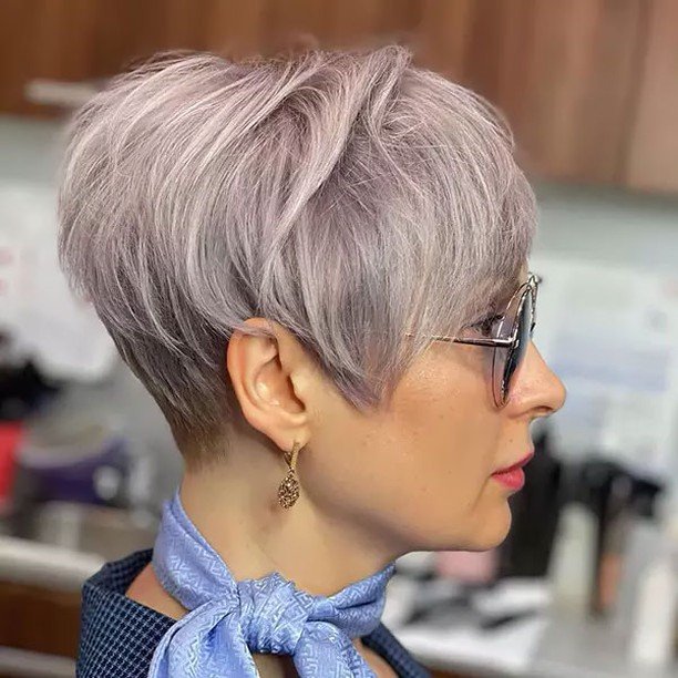 Chic silver pixie cut with soft layers and side-swept bangs – cute hairstyles for short hair.