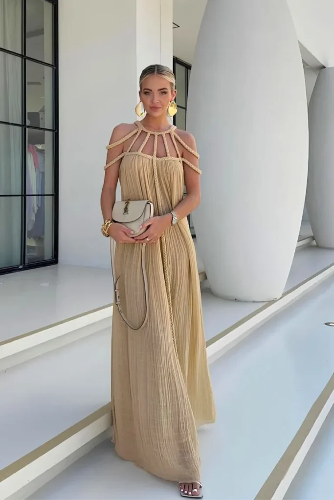Elegant summer look featuring a beige pleated maxi dress with rope details, accessorized with bold earrings and a neutral handbag — perfect for outfit ideas summer.