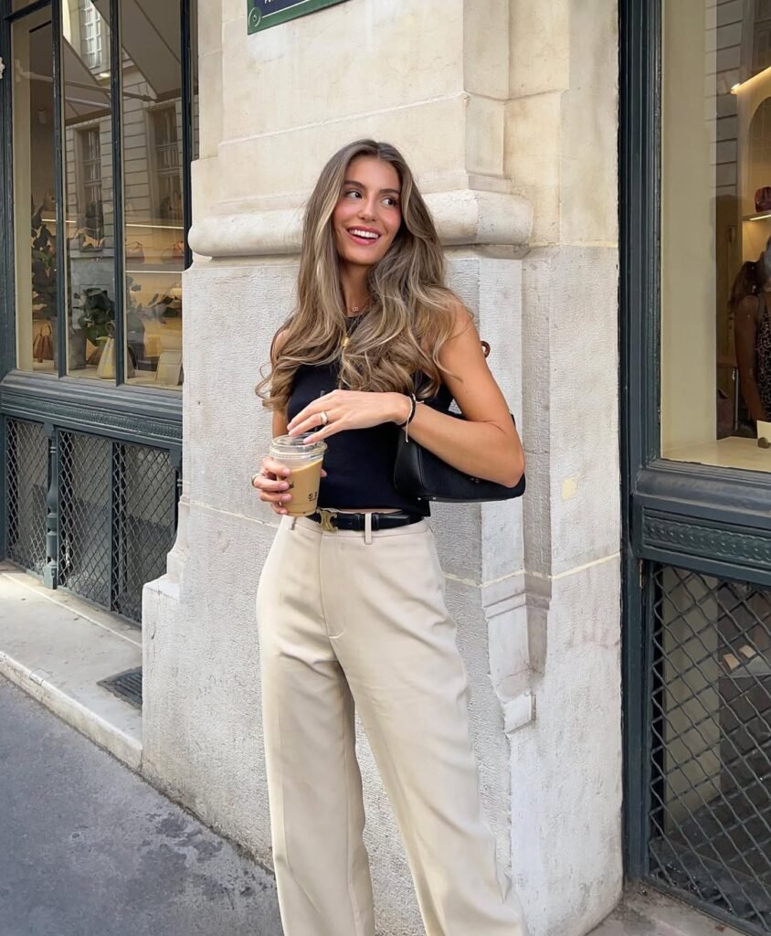 Summer-ready stylish work outfit with beige trousers and a sleeveless black top.