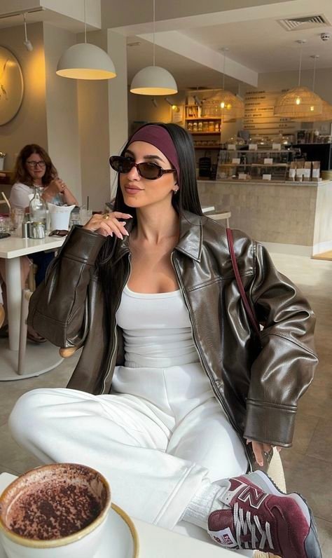 Relaxed brown Leather Blazer paired with white joggers, a fitted tank top, and sneakers — sporty-chic café style.