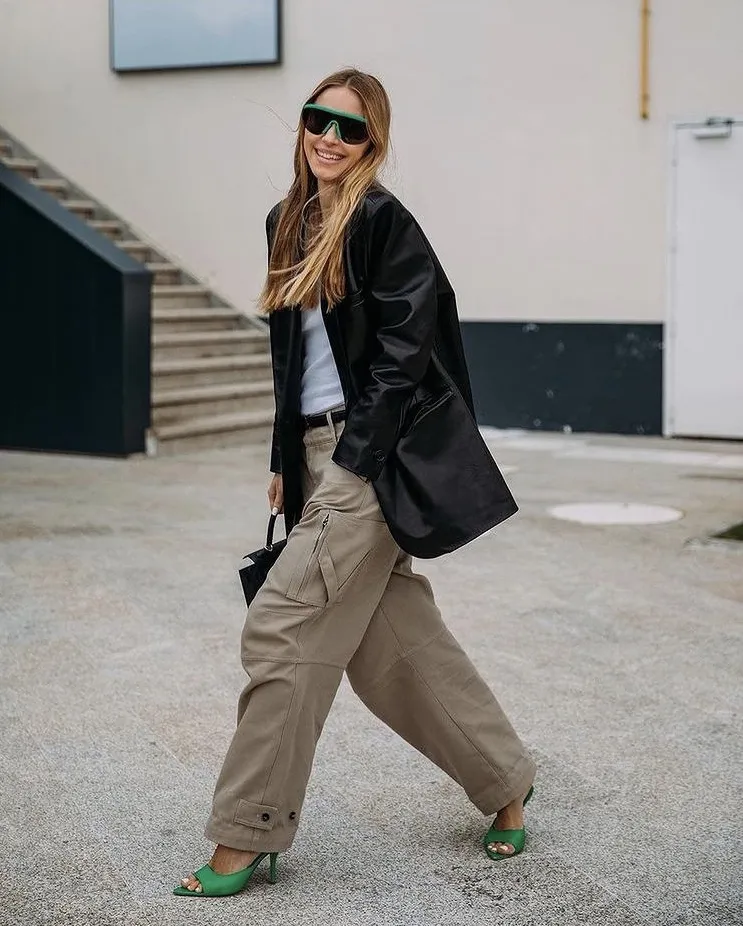 Relaxed Leather Blazer outfit with wide khaki cargo pants, a white top, and green heels, finished with oversized green sunglasses for a playful twist.