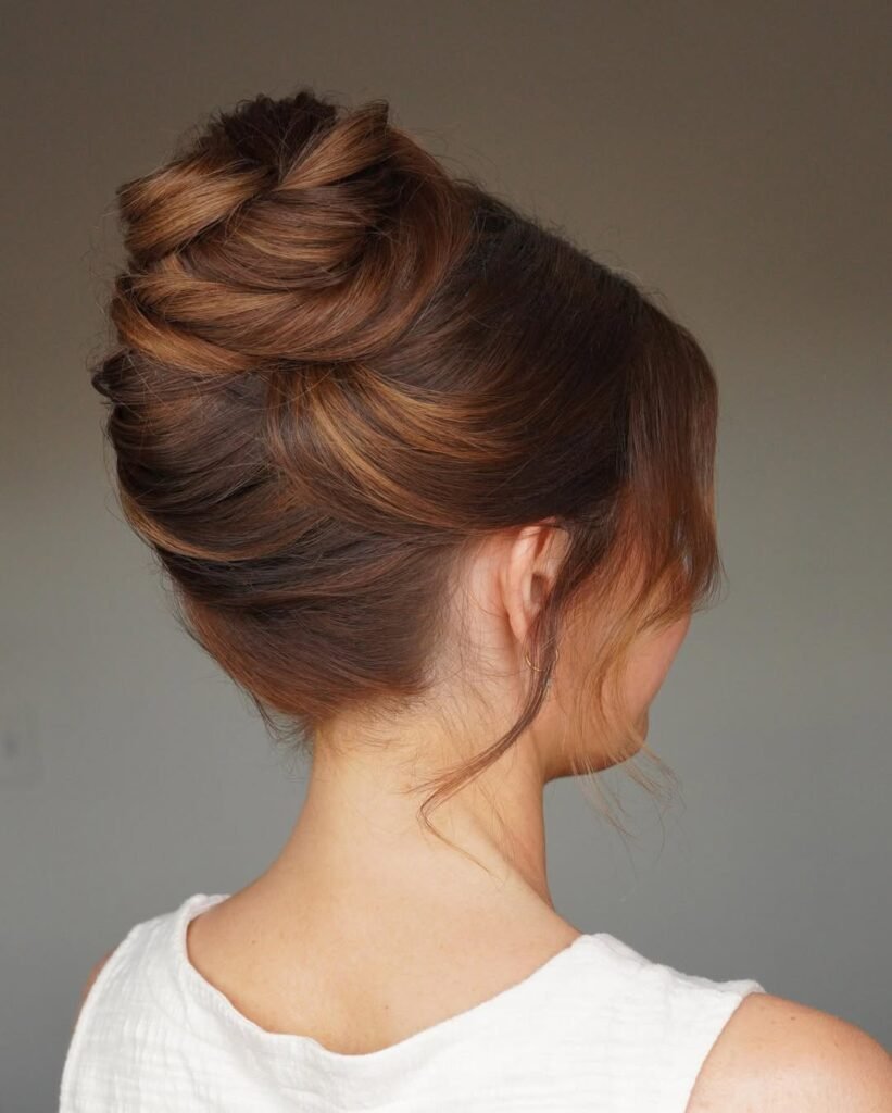 Classic elegant updo with twisted layers for a sophisticated look.