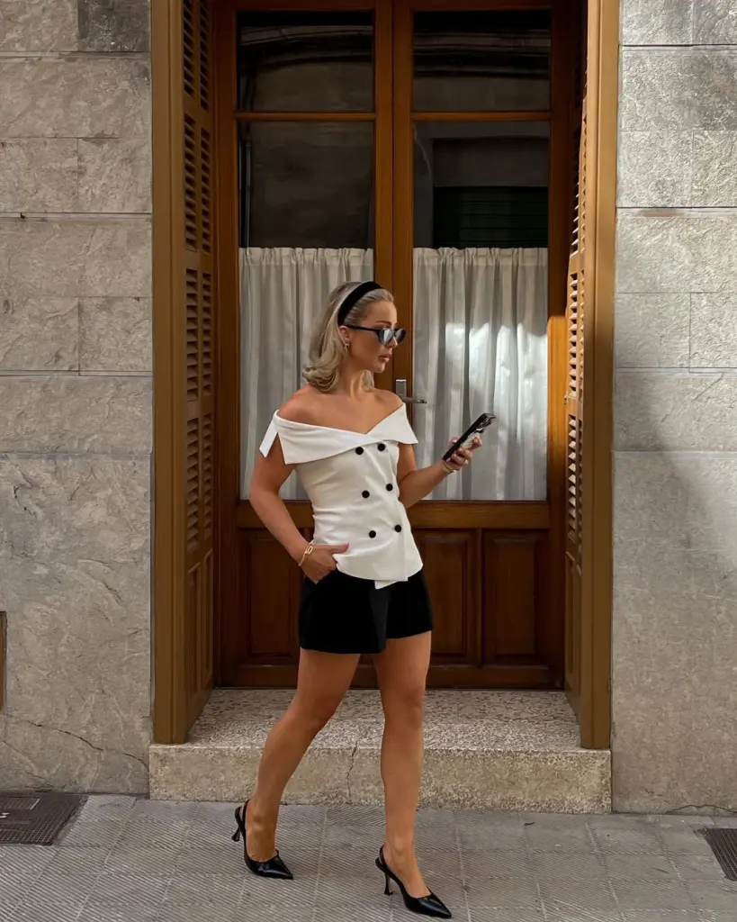  Chic monochrome look with off-shoulder top and heels – old money outfits with polished summer aesthetics.
