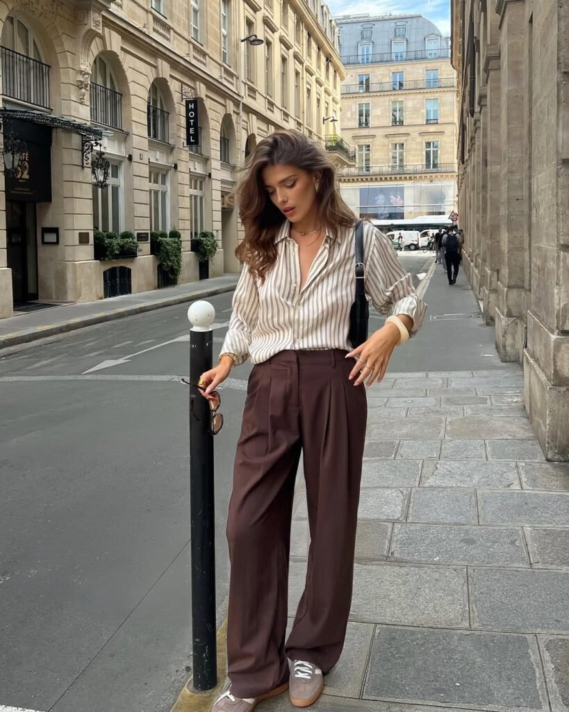 Elegant brown pants and striped shirt giving casual old money outfits vibe.
