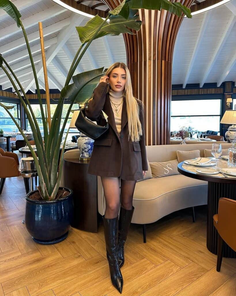 Woman posing outdoors wearing a cream-colored textured blazer over a matching knit outfit, highlighting trendy blazer outfits.