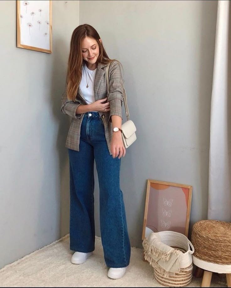 Smart-casual wide leg pants outfit featuring a plaid blazer over a white tee paired with blue denim and white sneakers.