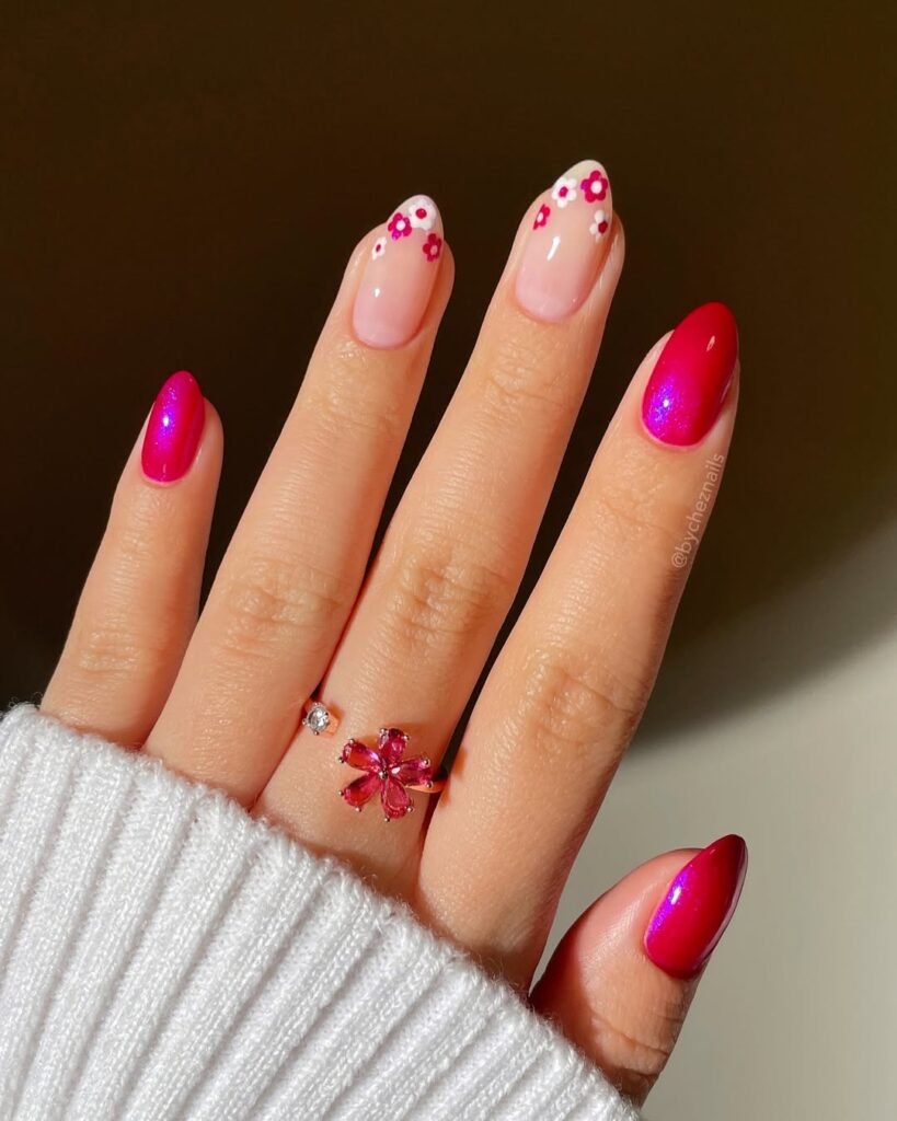 Spring Nail Ideas in vibrant magenta shades with shiny polish and playful pink and white floral accents.