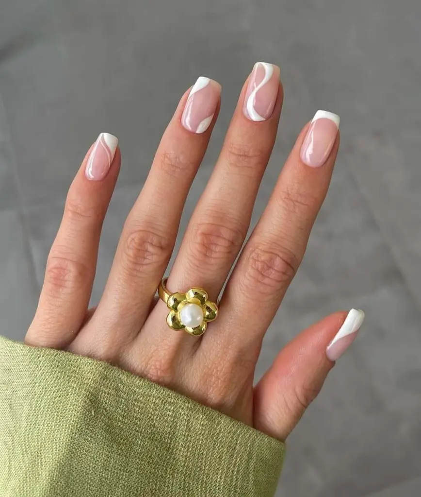 Chic white swirl French tip nail ideas on square-shaped nails with a soft pink base.