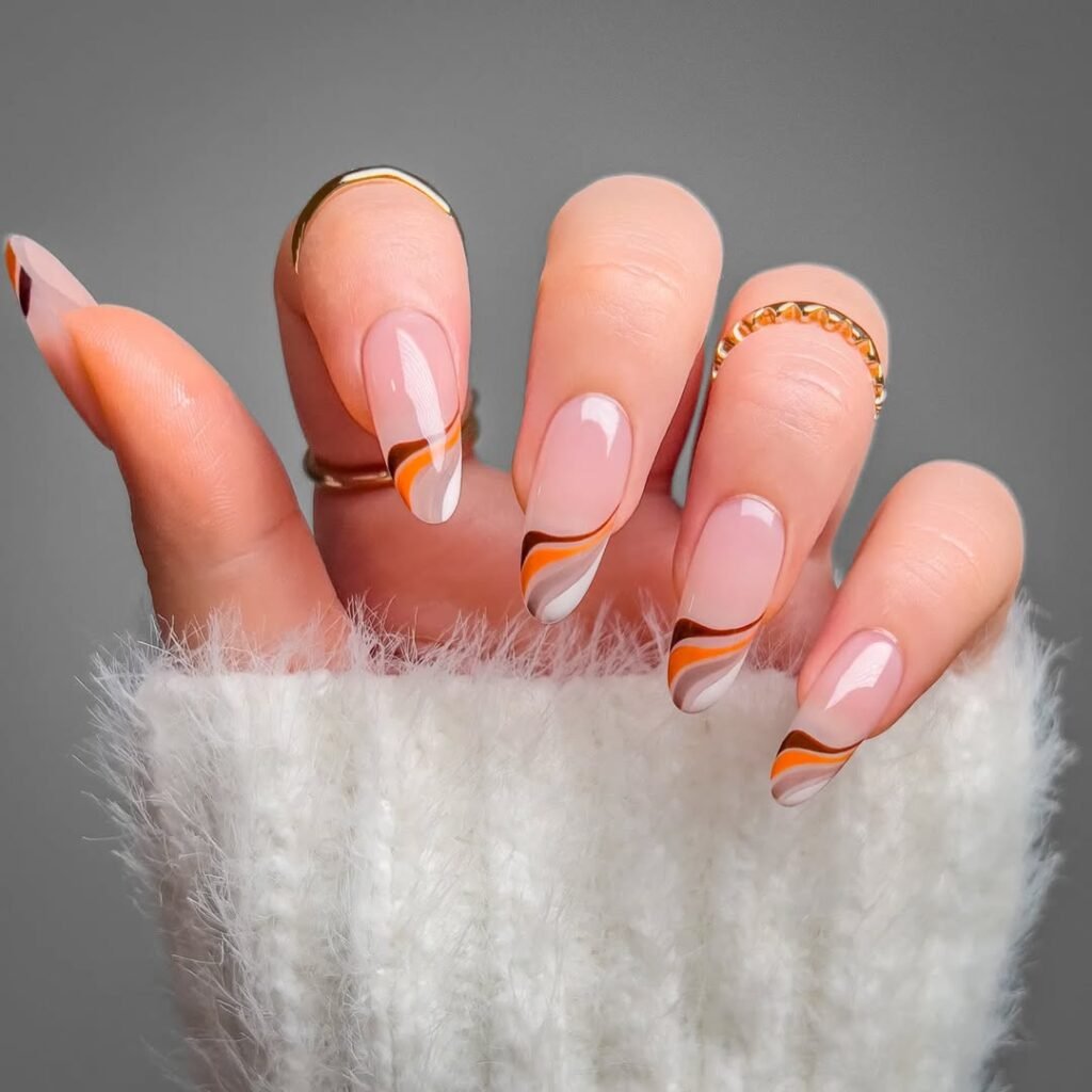 Retro-inspired swirl nail ideas in orange, white, and brown tones on long almond nails.