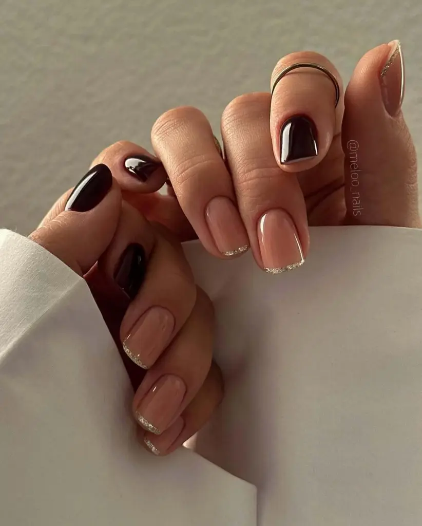 Elegant nail ideas mixing nude polish with dark chocolate tones and glitter French tips.