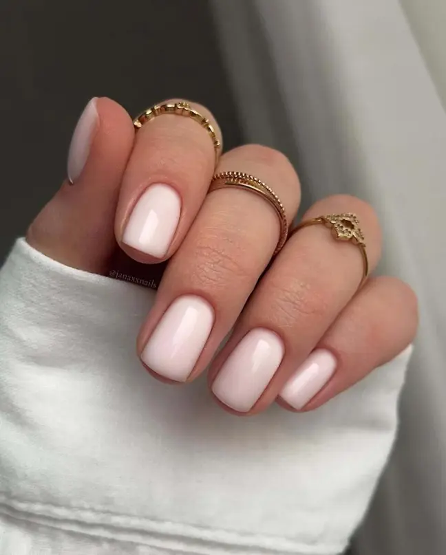 Minimalist light pink nail ideas with a glossy finish on short square nails for an elegant everyday look.