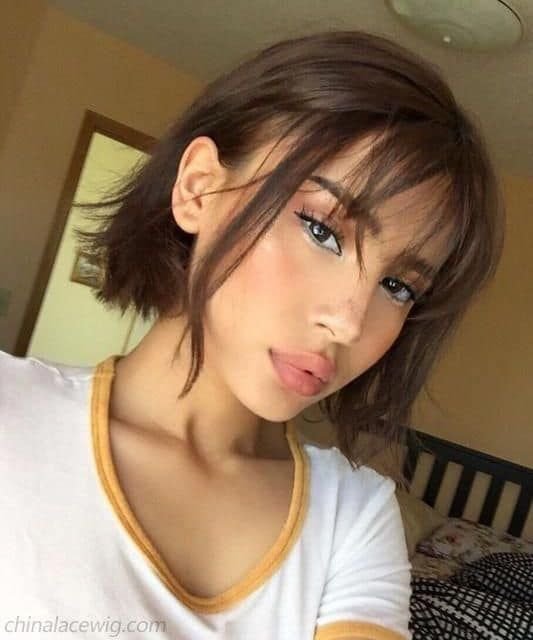 Cute Hairstyles for Short Hair showcasing a choppy bob with bangs and subtle layering, adding a youthful, flirty touch.