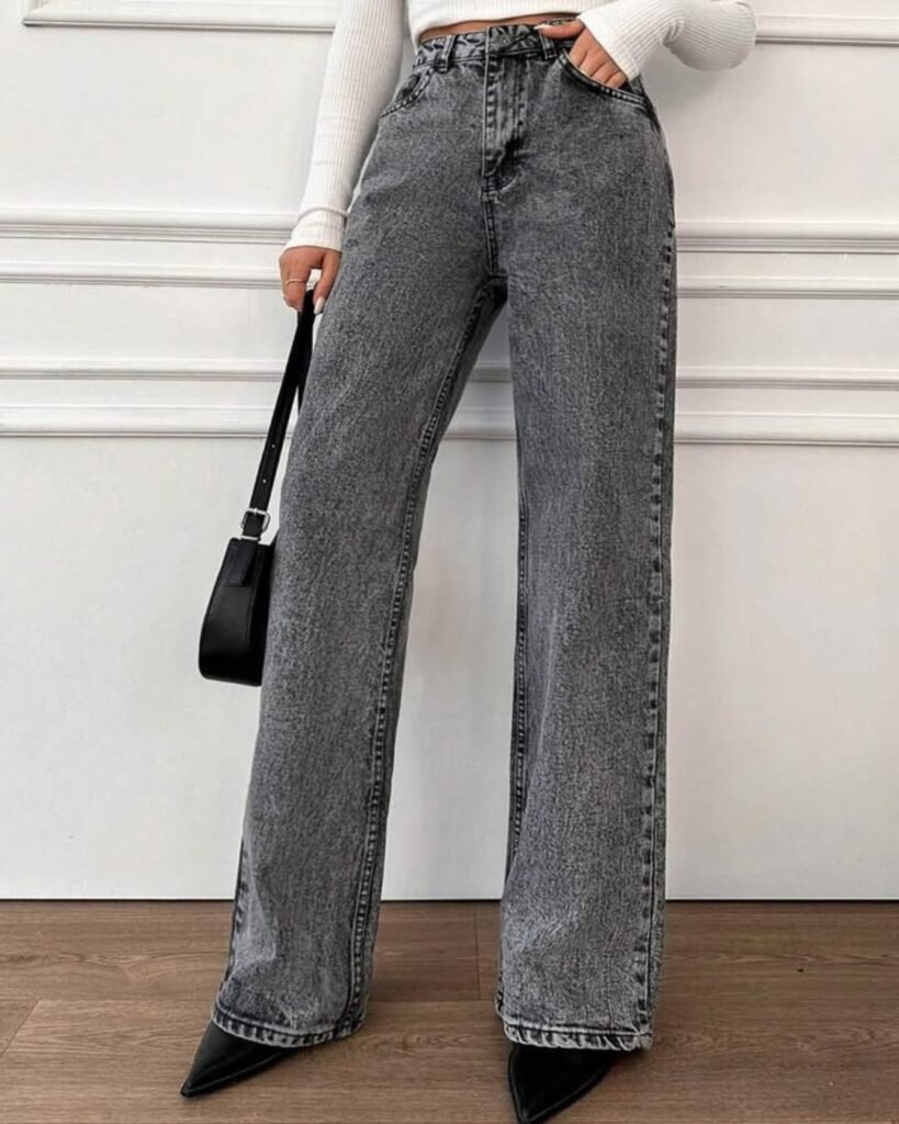 Trendy wide leg pants outfit with washed black jeans styled with a cropped ribbed top and black pointed heels.