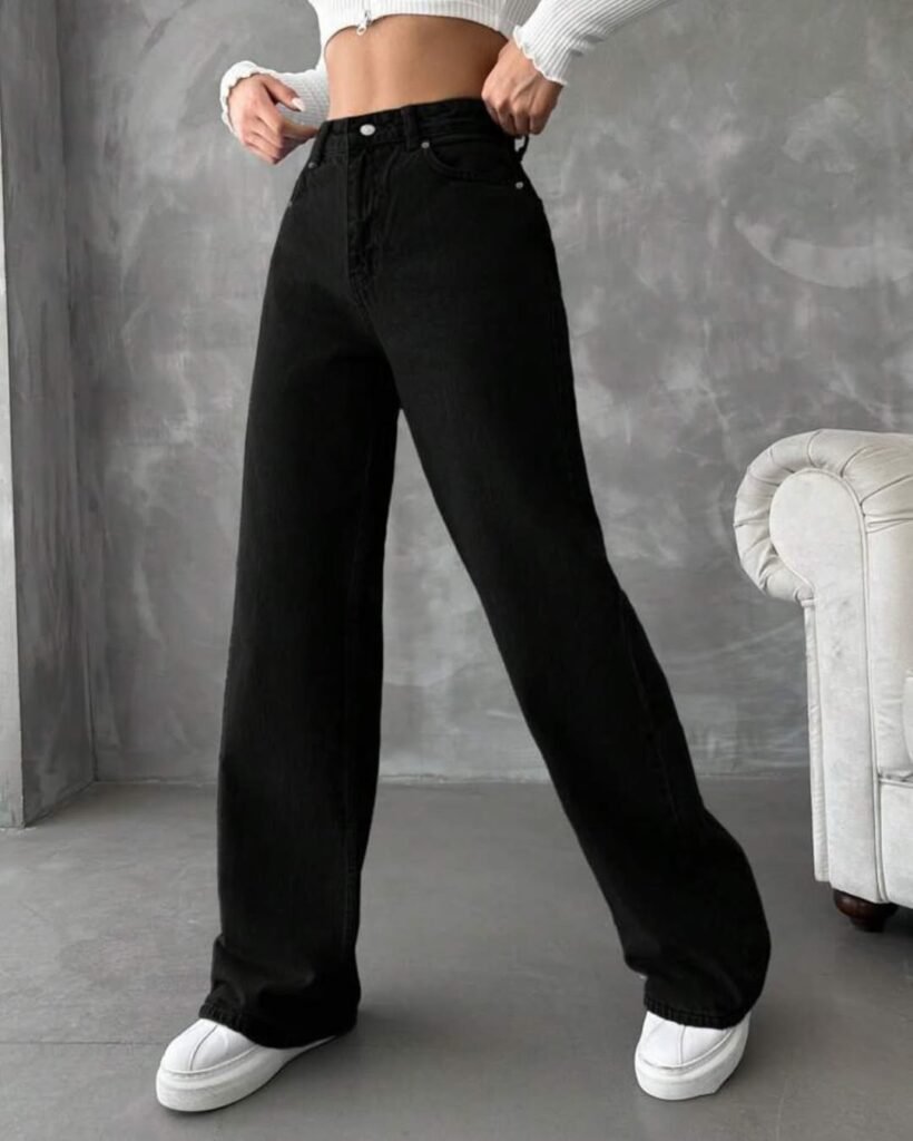 Casual wide leg pants outfit with black denim and a white ribbed crop top, completed with white platform sneakers.