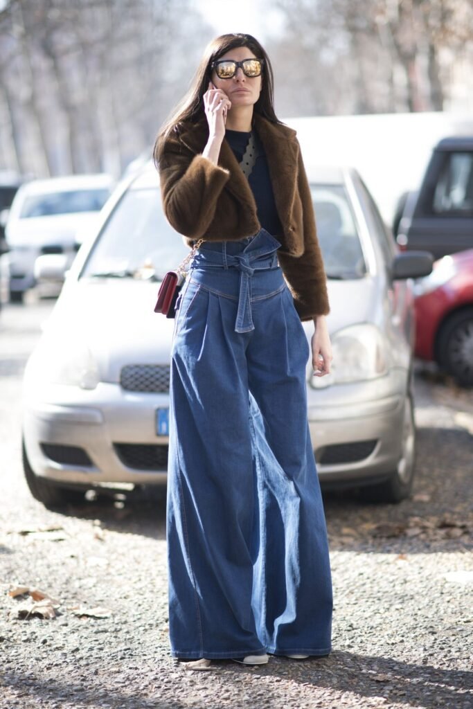 Statement wide leg pants outfit featuring ultra-high waist blue denim and a cropped brown faux fur jacket.