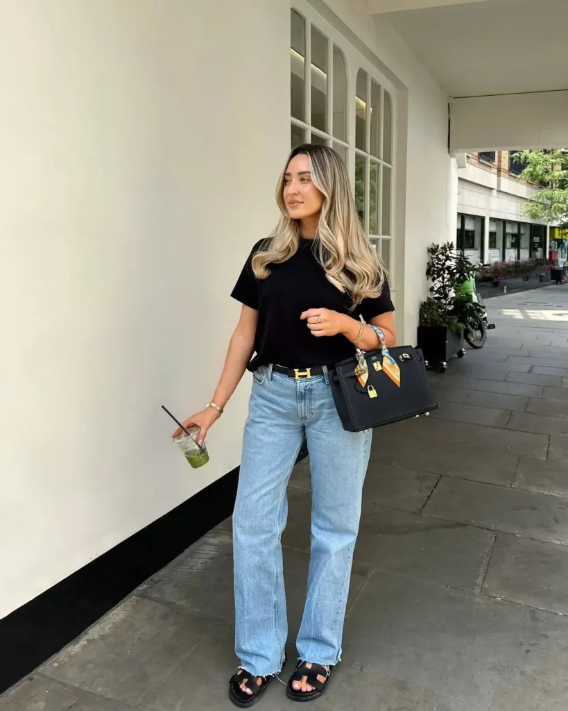 Simple yet polished Casual Summer Outfits consisting of a black tee, straight-leg jeans, black sandals, and a structured black handbag.