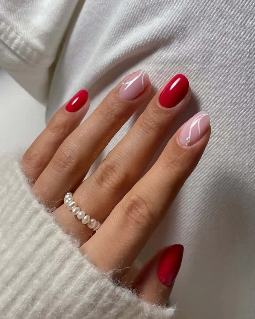 Modern red and pink nail ideas with white abstract lines and a pearl detail for a trendy mix.