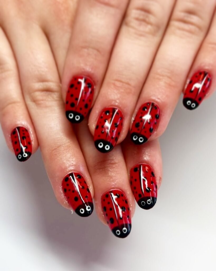 Stunning Nail Ideas featuring playful ladybug-themed nail art with red and black dots, complete with cute eyes for a whimsical finish.