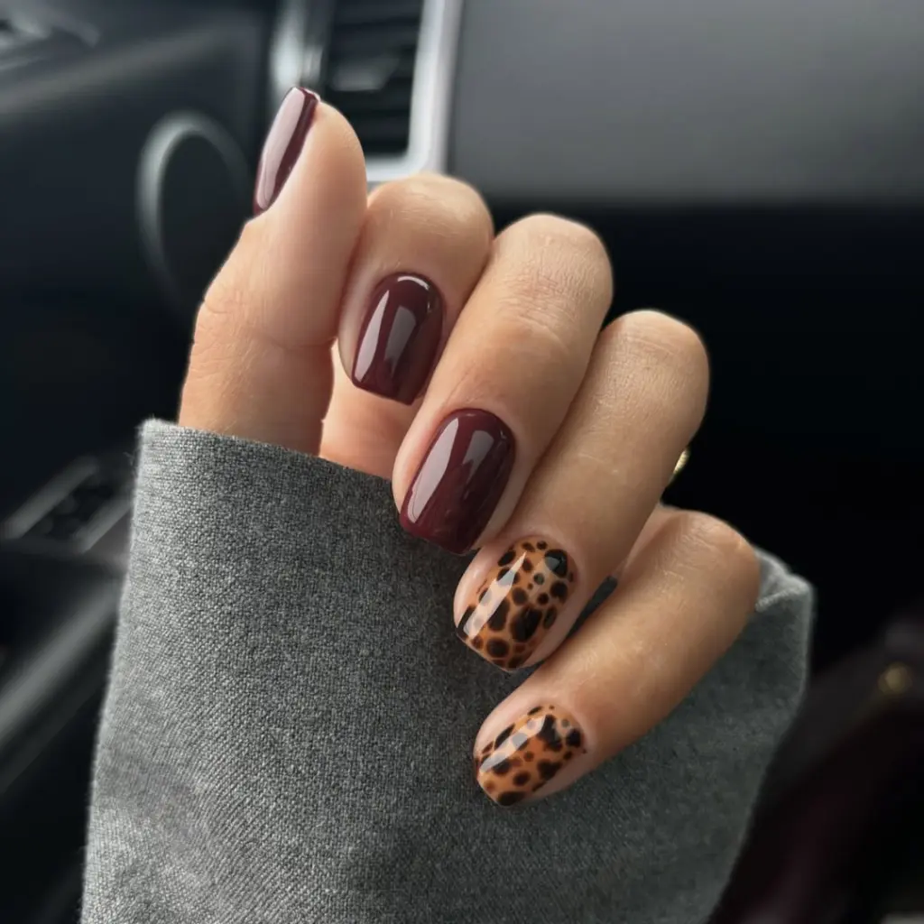 Short fall nail designs with deep burgundy polish and accent leopard print nails.