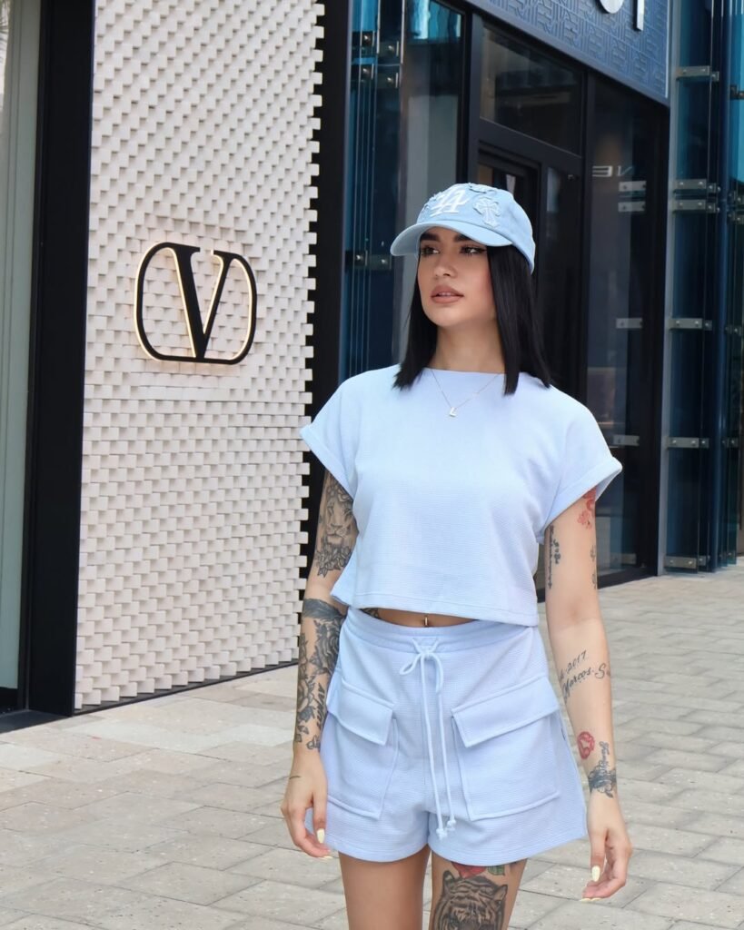 Cargo Shorts Outfits: Soft monochrome athleisure with sky blue drawstring cargo shorts, matching top, and baseball cap.