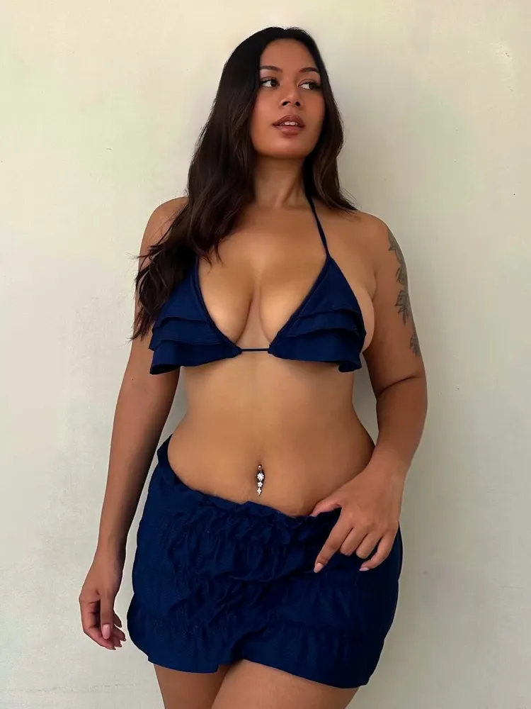 Bold navy Swim Shorts outfit with a ruffled triangle bikini top and a matching ruched mini swim skirt, exuding confident summer style.