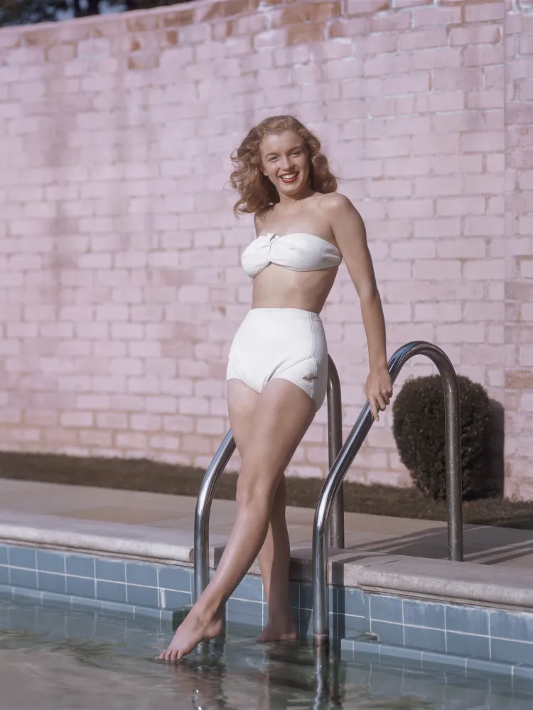 Classic vintage-inspired Swim Shorts outfit featuring a strapless white bikini top and high-waisted retro swim shorts, styled by the poolside.