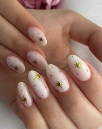 White Summer Nails with a soft matte ombré base decorated with delicate golden star and dot details.