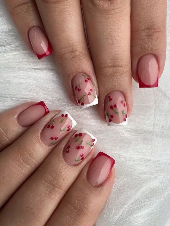 Square nude nails with alternating red and white French tips and cherry nail art.