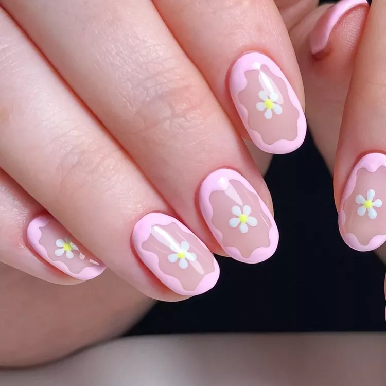 Pastel pink border and daisy-centered Stunning Nail Ideas over a nude base, creating a soft and delicate spring-inspired look.