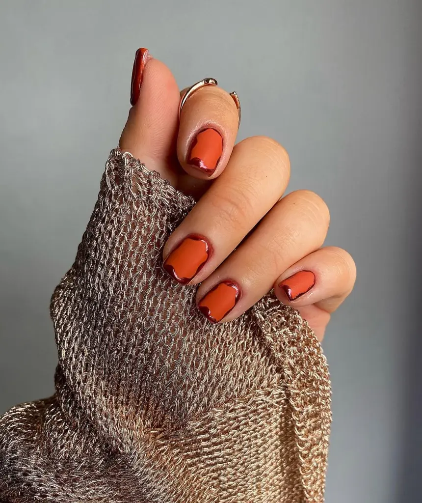 Short fall nail designs with burnt orange polish outlined in deep burgundy.