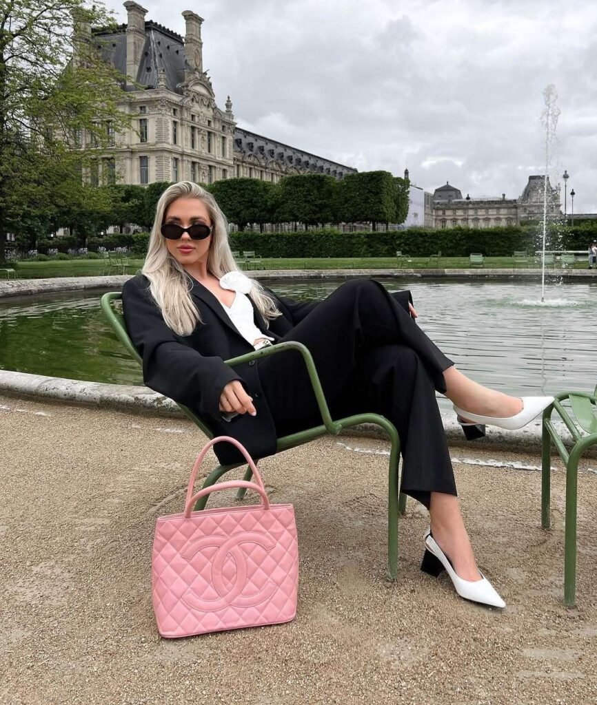 Old Money-Inspired Spring Outfit featuring a classic black suit with a white blouse and bold pink Chanel bag, exuding Parisian elegance.