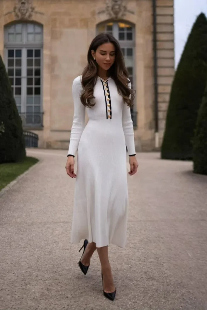 Old Money-Inspired Spring Outfit with a sophisticated white midi dress featuring gold buttons and black trim, paired with black pumps.