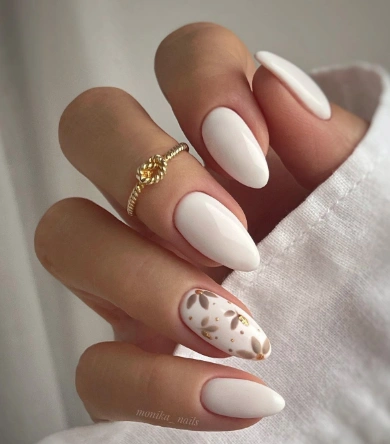 White Summer Nails in almond shape with a clean base and elegant brown-gold floral accent on the ring finger.