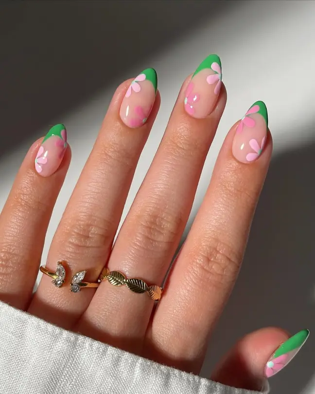 Playful Stunning Nail Ideas with green French tips and soft pink daisies, combining freshness and fun in a lively nail design.