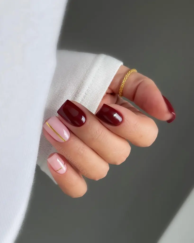 Short fall nail designs with burgundy polish and pink nails accented with gold lines.