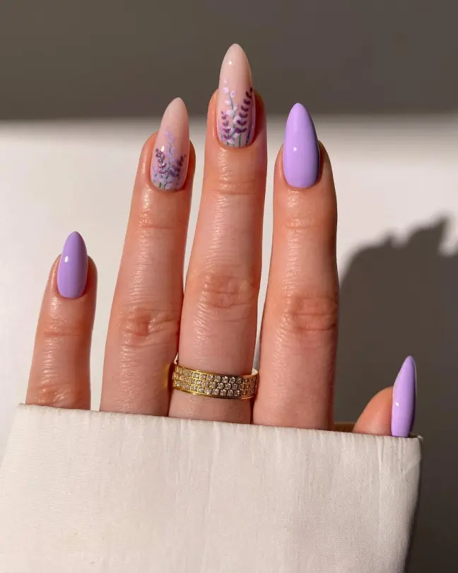 Lavender-themed Stunning Nail Ideas with solid lilac polish and botanical accents over a neutral base, offering a feminine and serene aesthetic.